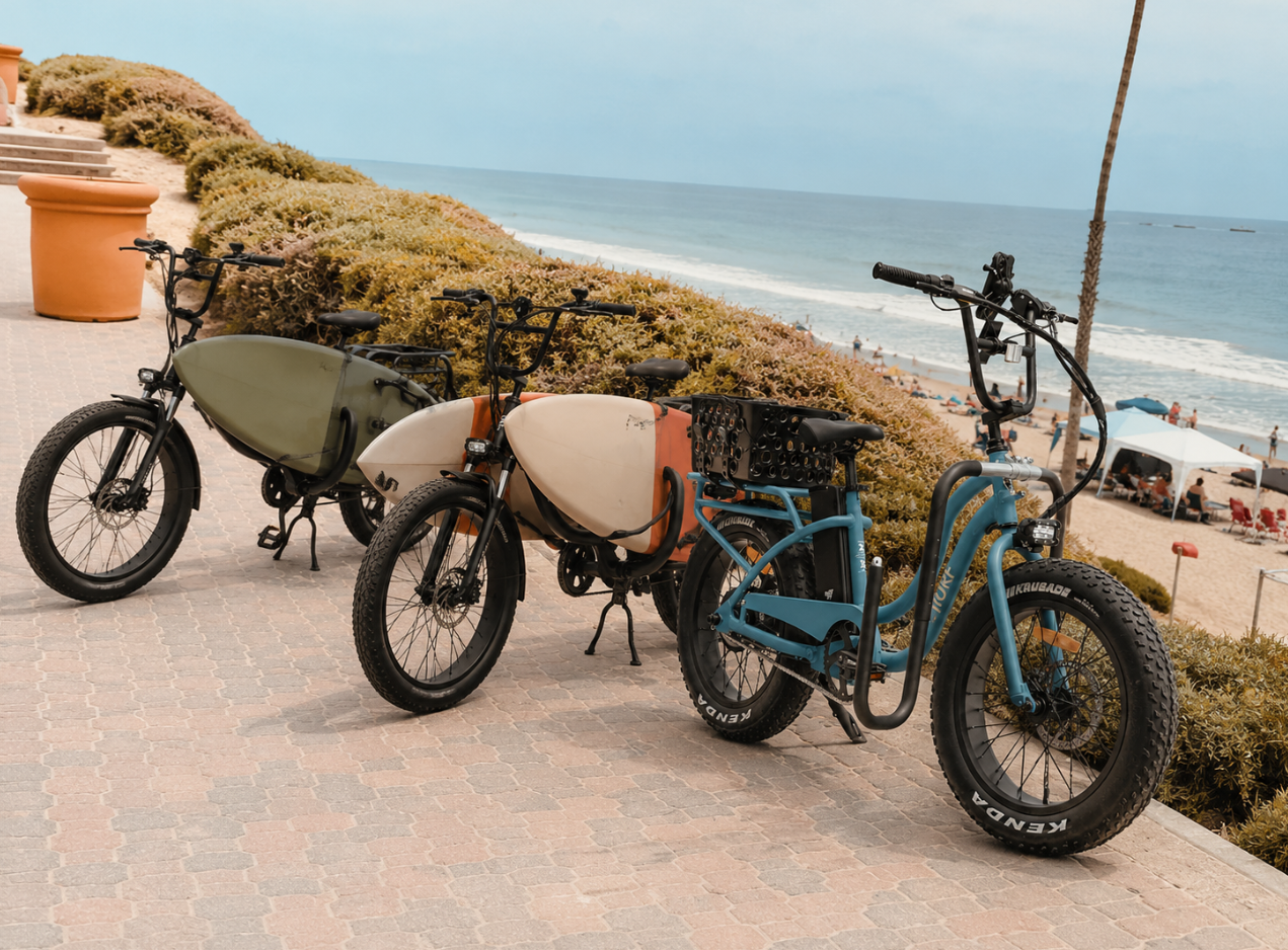Rider cruising an e-bike along the San Clemente beach trail at golden hour